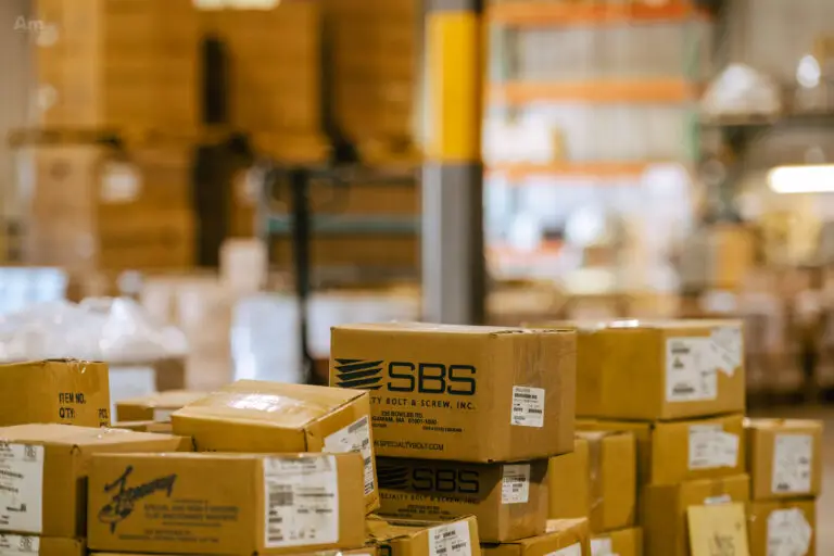 Stacked SBS-branded boxes in warehouse ready for shipment.