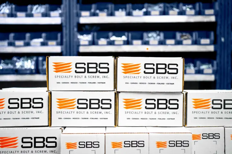 Boxes of fasteners from SBS in front of inventory solutions shelving.