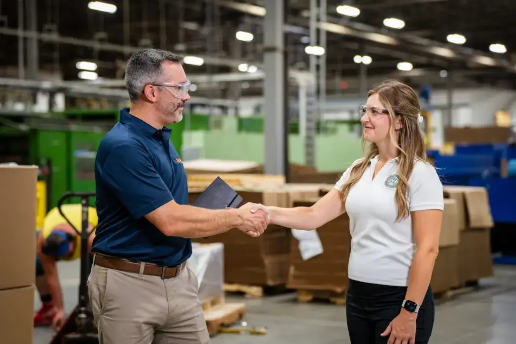 SBS account manager collaborating with a customer in a warehouse.