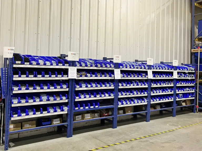 Organized racking with labeled bins after VMI implementation at a manufacturer.